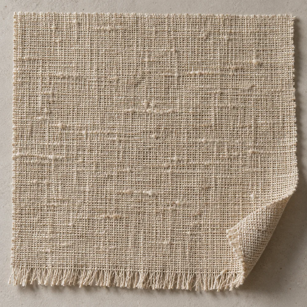 Warm oatmeal flax linen with an open, slubby weave and a softly fringed edge.
