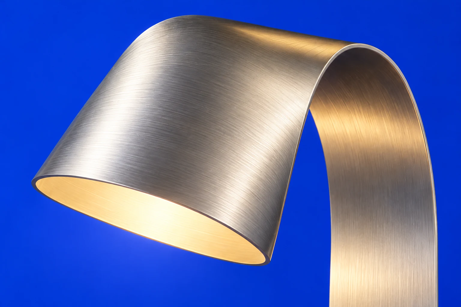 Material study: close view of the brushed silver Rill 01 hood and its warm underside light.