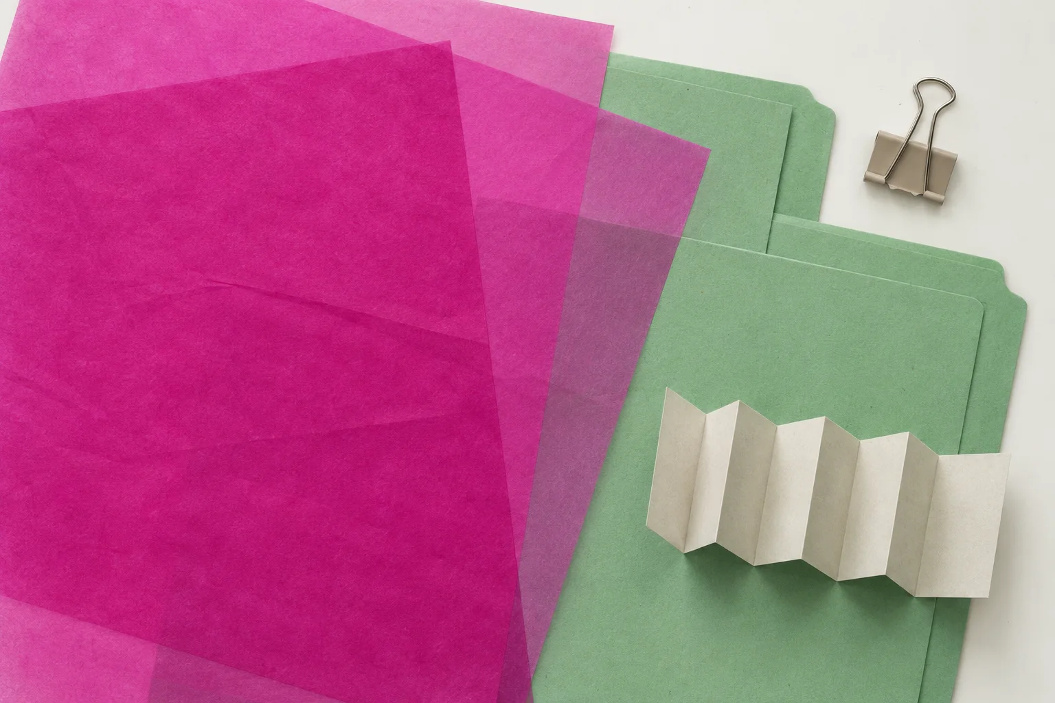 Illustrative scanned paper archive with magenta and green sheets arranged as documentary material