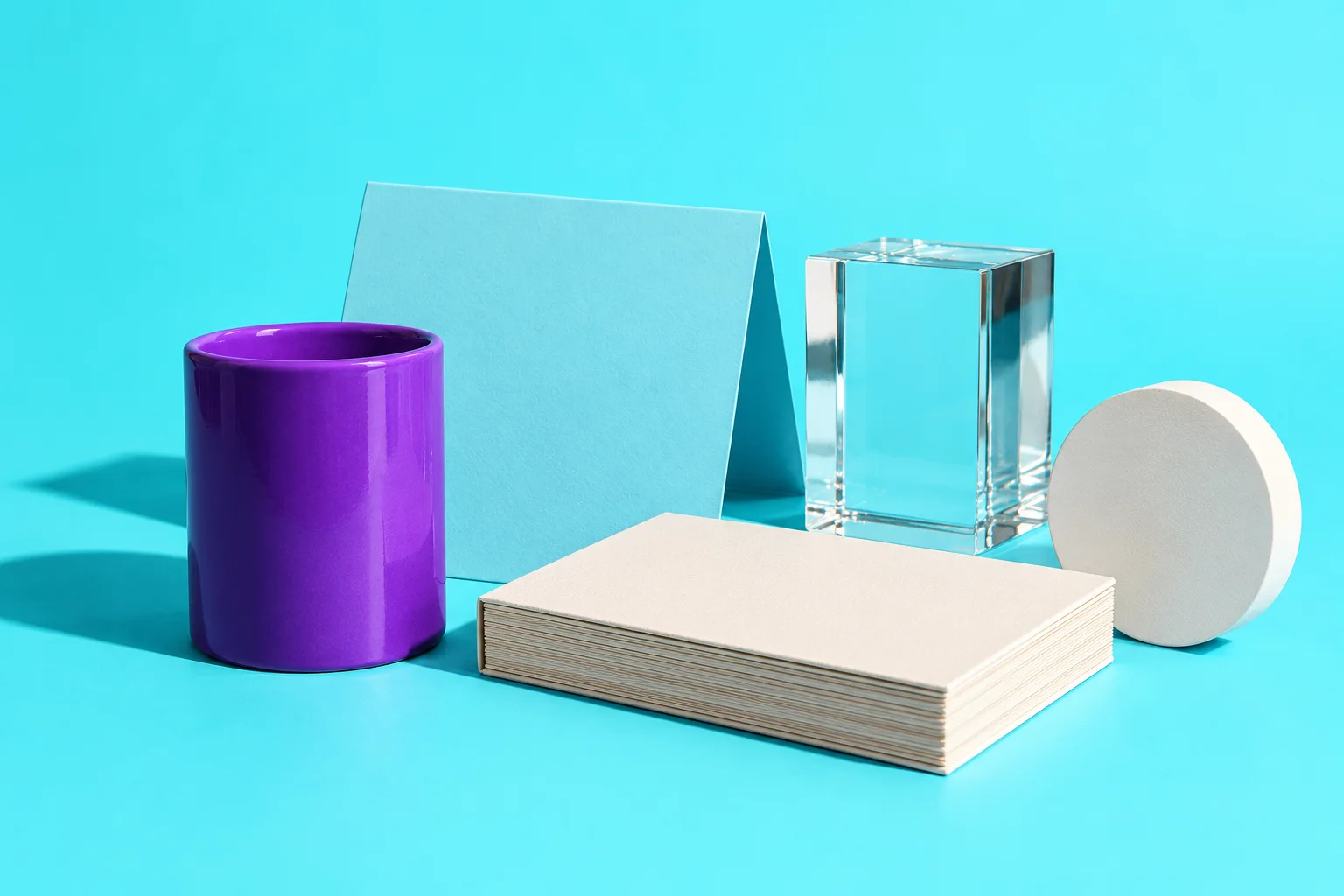 Illustrative violet and cyan catalog objects arranged with blank cards